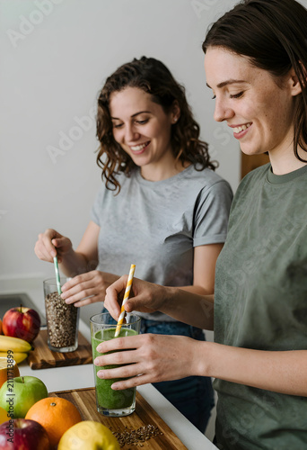 Two smiling women preparing...