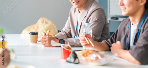 Tableau sur toile Businessmen (boss and subordinate) having lunch in the company office