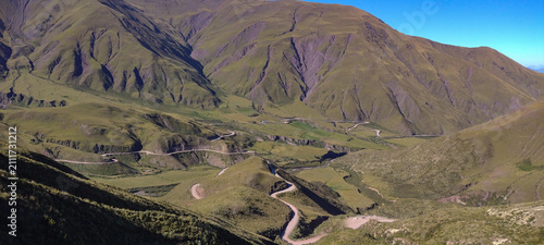 Konstfotografi Winding Switchback Road Through Green Mountain Landscape