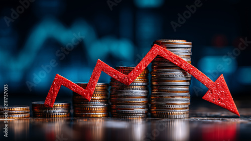 Stacks of coins crossed by a falling arrow represent financial decline and investment losses during recession and economic uncertainty.
