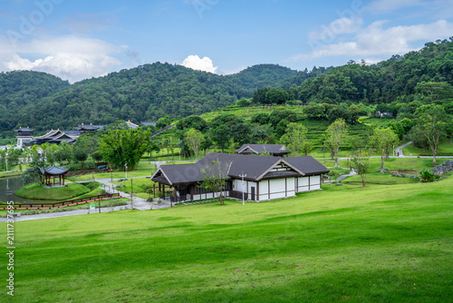 Принти на полотні A landscape of Oriental-style gardens, embraced by green hills and carpeted with lush, verdant lawns