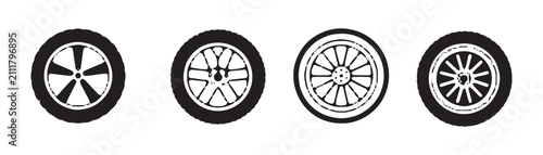Set of four different automotive wheel rims and car tires isolated on white background black icons.
