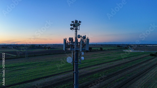 фотографія Cell tower transmitting modern telecommunication signals and 5G network connecti