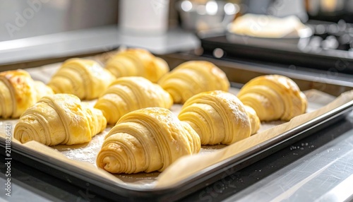 Freshly baked croissants on tray ready.