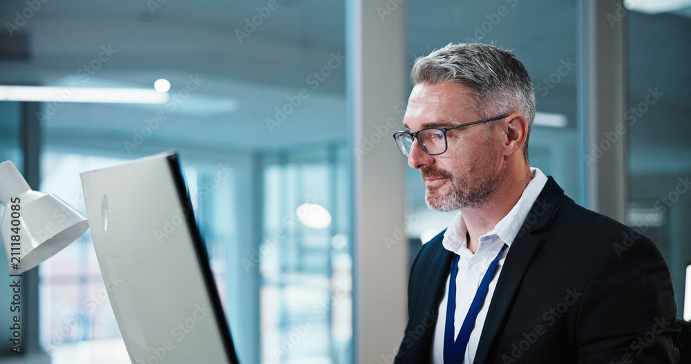 Fototapeta premium Business, man and smile with computer in office for risk assessment, finance news or insight. Review, mature financial advisor and tech at agency for market tracking, ai scenario planning and reading