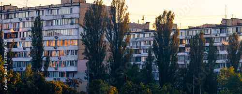 фотографія City apartment buildings stand tall, with numerous windows and balconies reflect