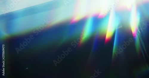 Light reflect burst illuminating the brilliance of a reflective prism. Radiant lighting creating a visual effect of light refraction in a rainbow colors and a dreamy rays of lights background. Loop