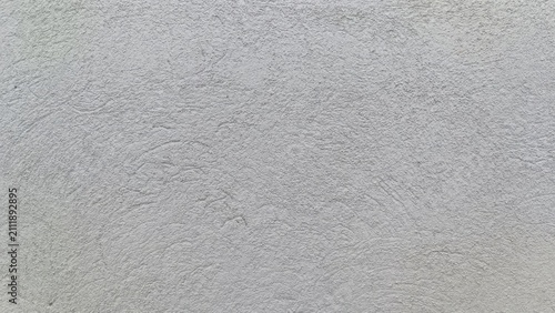 Slika na platnu Close up of a hand troweled light gray concrete wall with granular bumps and swirling patterns, creating a neutral, utilitarian surface texture