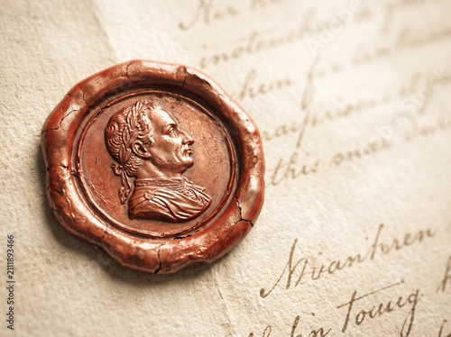 Brown wax seal with a portrait profile on an old handwritten letter
