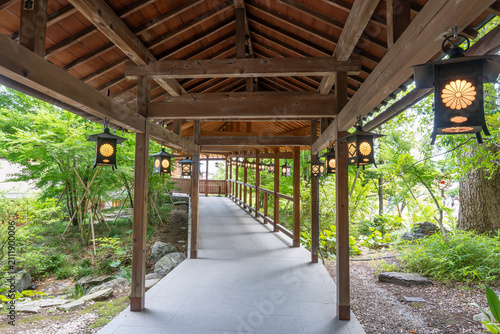 Covered Wooden Walkway with Hanging Lanterns at Japanese Shrine