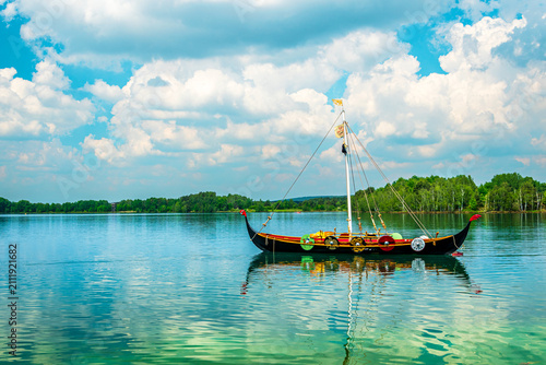 Foto Viking ship replica on calm forest lake
