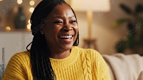 Woman wiping tears with white tissue while laughing happily