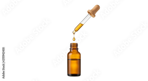 Photography Amber glass dropper bottle with golden liquid dripping into it