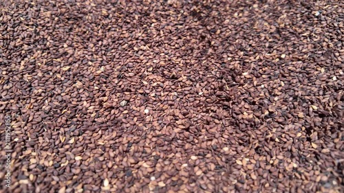 Closeup of a bunch of black sesame seeds pouring from top