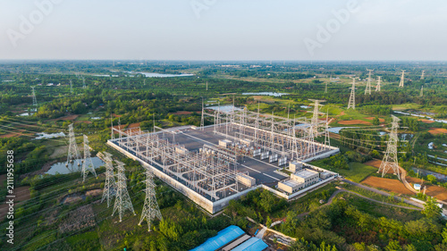 Obraz na płótnie An aerial view of a large high-voltage electrical substation situated in a green rural area with surrounding natural landscapes