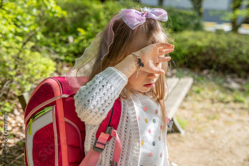 little girl carrying heavy pink school backpack, bag, strain on shoulders and posture, childhood health concern, excessive school load, education pressure, safety and wellbeing, daily routine risk