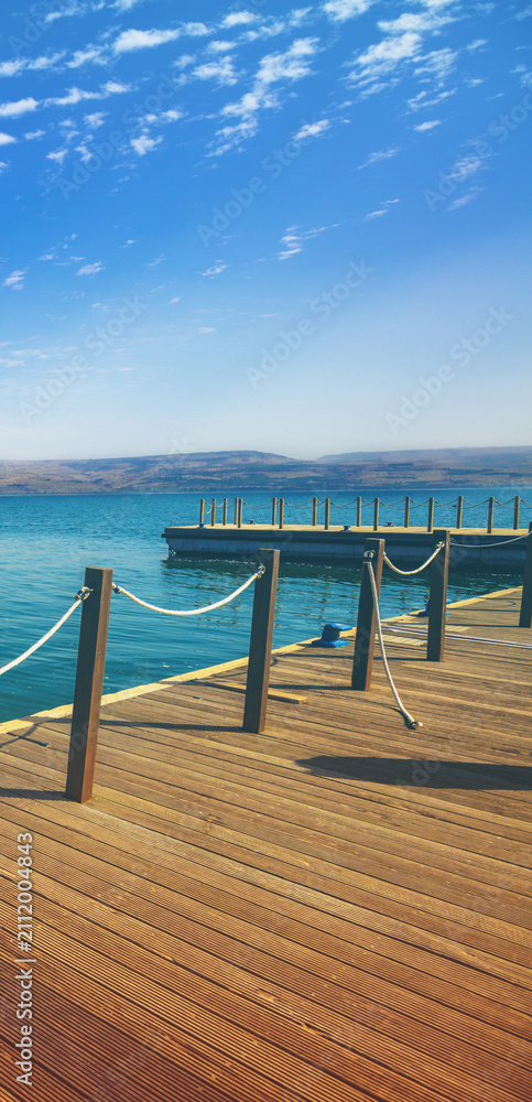 Fototapeta premium Wooden pier in the sea. Sea of Galilee, Capernaum, Northern Israel