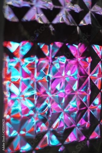 Light and color purple, red, and blue reflected and shifted across the cube's surface like a diamond, revealing a unique beauty that creates a modern and futuristic feel.
