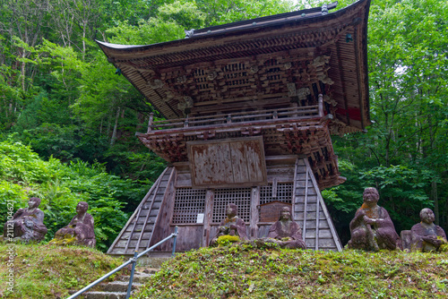 Bild auf Leinwand Ancient Stone Buddha Statues in Japanese Temple Garden, Mossy Religious Monument