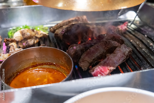 Sirloin Hanwoo Beef, marbled Korean Style Meat on the Grill. BBQ rare meat with soft focus