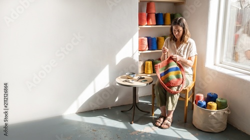 Maker finishing a colorful crochet bag in a sunlit studio