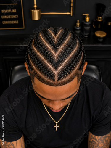 Man with braided hairstyle in a barbershop