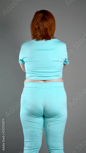 Unrecognizable curvy woman performs exercises for muscles of upper back, arms and buttocks, posture correction and physical therapy concept