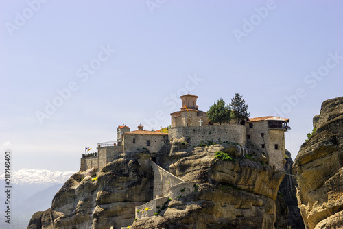 Quadro su tela The Holy Monastery of Great Meteoron perched atop a rock formation in Meteora, Greece, under a clear blue sky