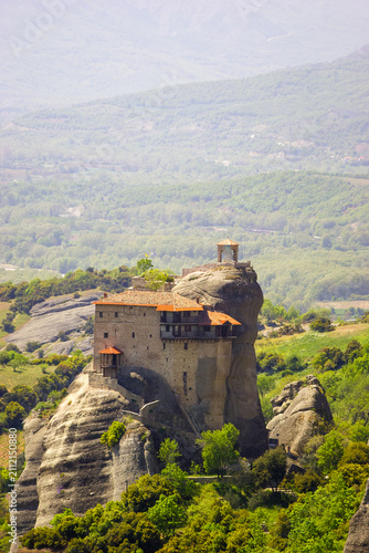 Quadro su tela The Monastery of Great Meteoron, perched atop a rock formation in Meteora, Greece, under a hazy sky