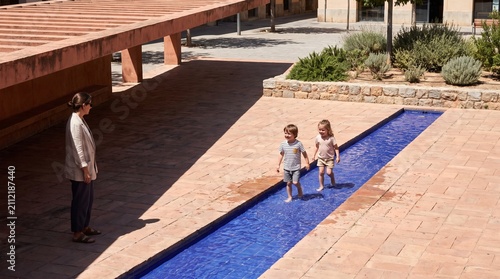 Children cool off at a water rill in a heat-ready plaza