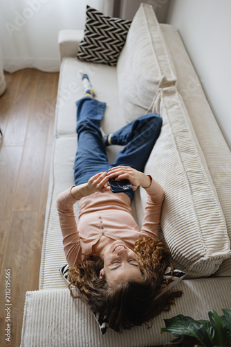Relaxed and happy woman scroll social media and reading on her phone