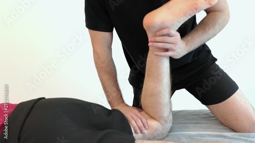 Physical therapist performing quadriceps stretching massage isolated on white background