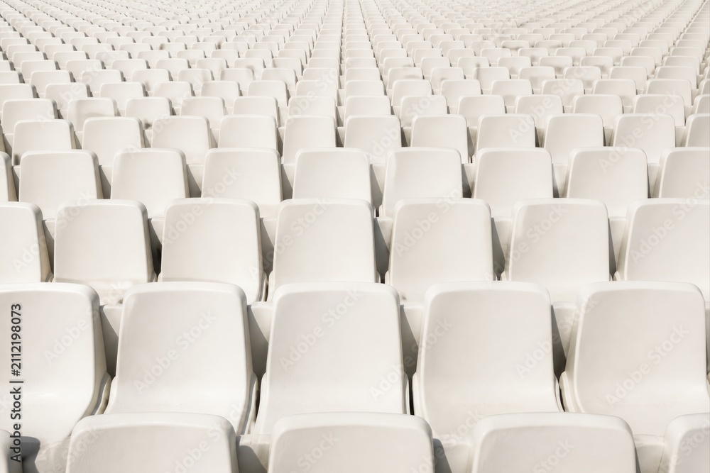 Fototapeta premium Empty stadium seats in bright rows of white seating