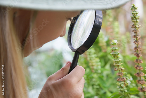 Obraz na plátně Young Nature Explorer Studying Plants in the Garden