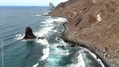 Aerial Drone Scenic View of Sea Waves on Black Volcanic Sand at Playa de Benijo, Tenerife. Dramatic Coastline with Rock Formations, Atlantic Ocean, and Wild Natural Landscape in Canary Islands.
