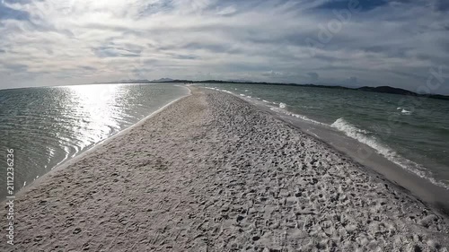 POV Walking Along a Narrow Sandbar Surrounded by Lagoon Water at Arubinha, Brazil