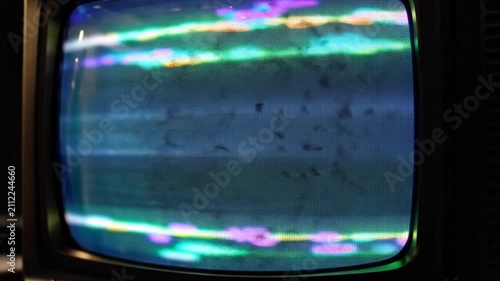 Vintage television screen with distorted colorful static interference