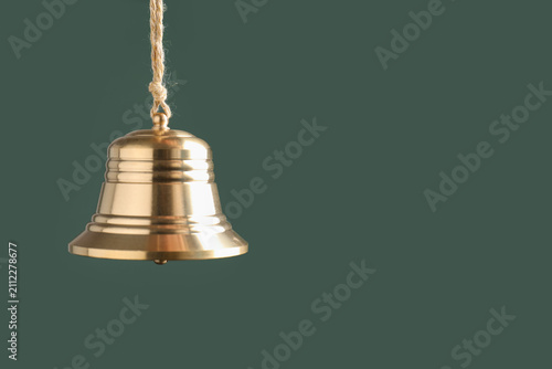 фотографія Beautiful golden bell on dark green background, closeup