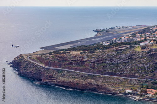 passenger jet on final approach to madeira airport at funchal no logos high view looking down on runway