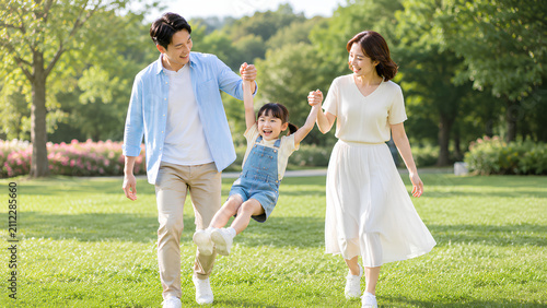 Happy Asian Family Enjoying Quality Time Together in a Sunny Park with Young Daughter