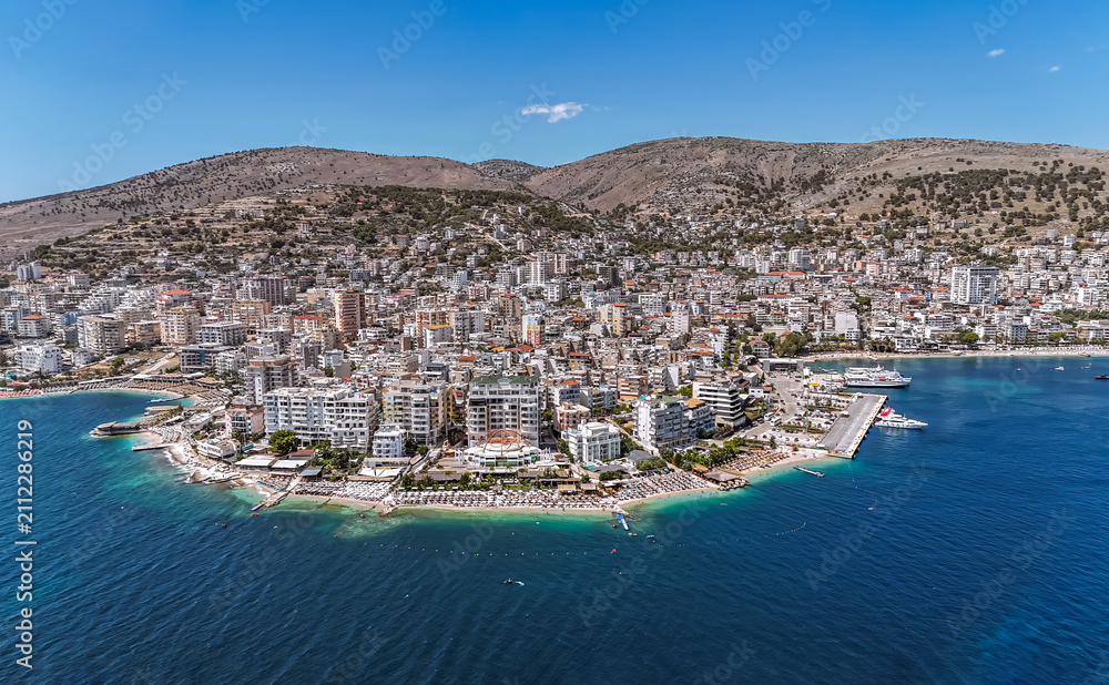Fototapeta premium Aerial view of downtown district of Saranda, Albania. Sarandë is a coastal city on the Ionian Sea and the unofficial capital of the Albanian Riviera. 