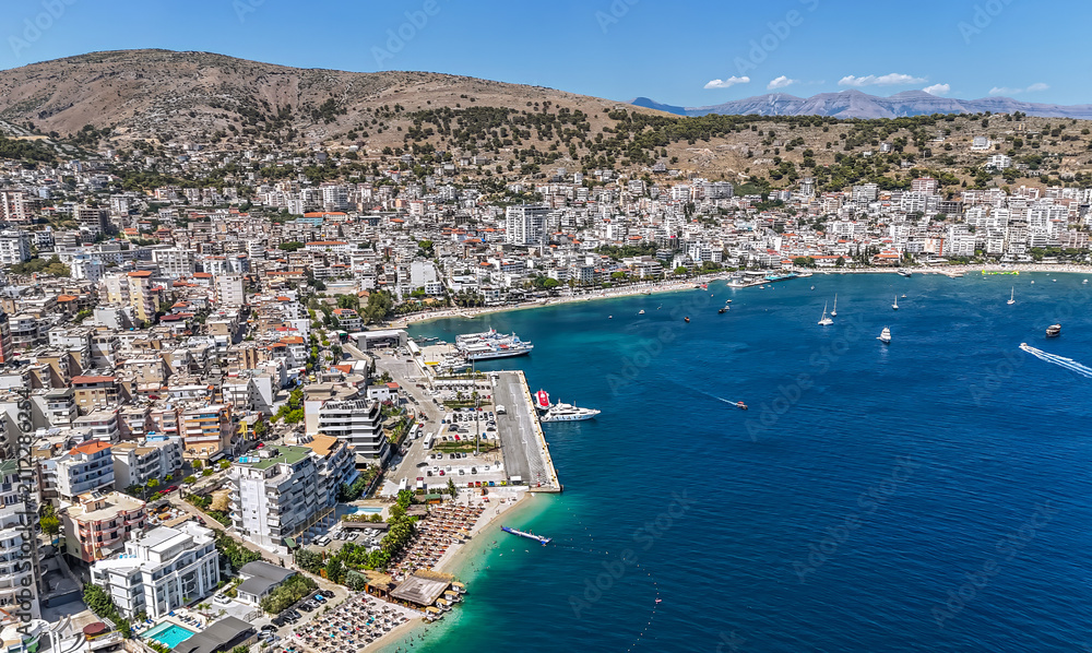 Fototapeta premium Aerial view of downtown district of Saranda, Albania. Sarandë is a coastal city on the Ionian Sea and the unofficial capital of the Albanian Riviera. 