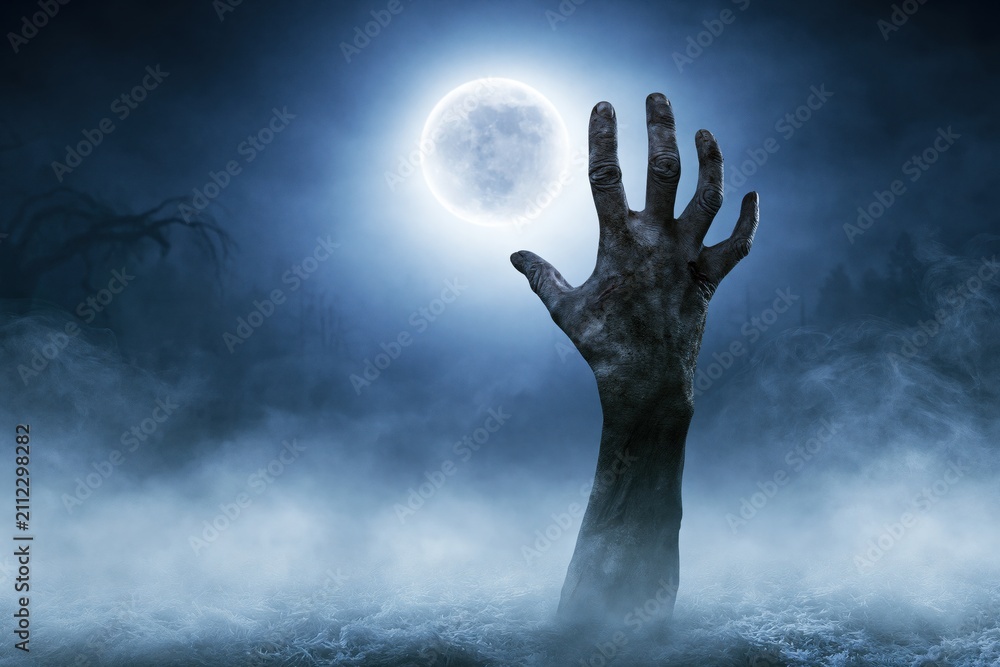 Obraz premium Creepy Zombie Hand Rising from Ground in Foggy Night Horror Halloween Background