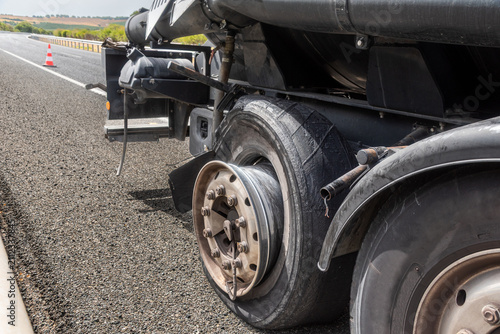 Truck with blown tire stopped on roadside for emergency