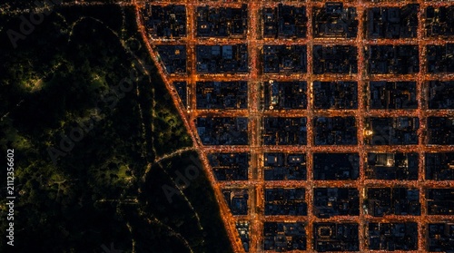City streets and park area lit up at night with a view from above showing the layout of roads and buildings