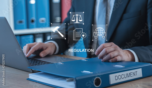 Professional businessman managing corporate regulation and compliance policies using modern laptop technology.