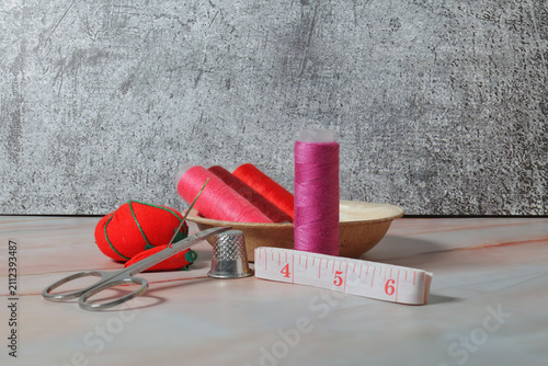 Obraz na plátne sewing tools: needle, thimble, tape measure, spool of thread
