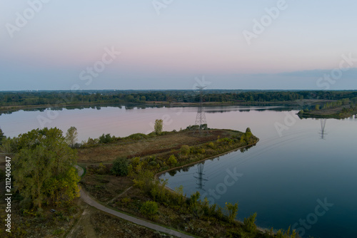 Power lines reflecting on Crandell lake water at dawn