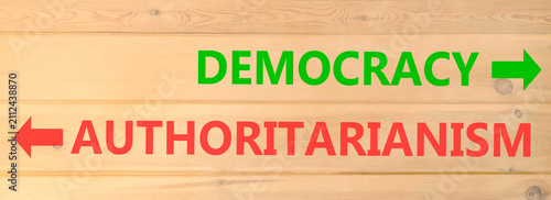 Foto Democracy or authoritarianism words symbol