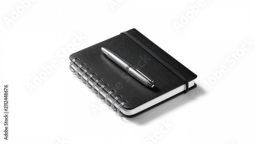 A pen resting on a black notebook with a spiral binding.